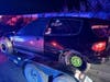 Officers pulled over a truck towing a trailer carrying a race car and arrested the four, police said.