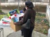 A woman leaves with a box filled with toys during the Archdiocese of Newark Mercy House’s annual Christmas Toy Giveaway on December 17, 2021.