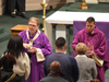 Cardinal Tobin and Father Camilo E. Cruz-Bahamon, pastor of St. Patrick’s Pro-Cathedral, distribute ashes to long lines of Catholics during an Ash Wednesday Mass at the Pro-Cathedral on March 2, 2022. 