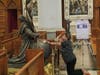 A woman in prayer touched a life-sized replica of Timothy Schmalz’s “I Embrace You” sculpture on display at Newark’s Cathedral Basilica of the Sacred Heart on September 12, 2022.