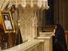 A woman in mourning prays before an image of Pope Emeritus Benedict XVI at Cardinal Joseph W. Tobin’s Memorial Mass for the late pontiff in Newark’s Cathedral Basilica of the Sacred Heart on January 12, 2023.