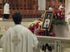 An archdiocesan priest prays before an image of Pope Emeritus Benedict XVI during Cardinal Joseph W. Tobin’s Memorial Mass for the late pontiff in Newark’s Cathedral Basilica of the Sacred Heart on January 12, 2023.