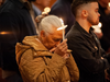A community member prays while holding a lit candle during the festival of lights at the Easter Vigil celebrated by Cardinal Joseph W. Tobin at Newark’s Cathedral Basilica of the Sacred Heart on April 8, 2023.