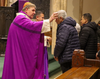 Cardinal Joseph W. Tobin, Archbishop of Newark, spreads ashes on a community member’s forehead during an Ash Wednesday Mass at St. Patrick’s Pro-Cathedral in Newark on February 14, 2024. 