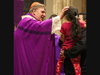 Cardinal Joseph W. Tobin, Archbishop of Newark, spreads ashes on a young community member’s forehead during an Ash Wednesday Mass at St. Patrick’s Pro-Cathedral in Newark on February 14, 2024. 