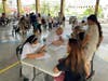 Father Joseph D’Amico (sitting) and other members of St. Anastasia Church’s medical mission team register people seeking health care in the Tondo district of Manila, the Philippines. 