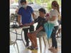 A member of St. Anastasia Church’s medical mission team checks the blood pressure of a man in the Tondo district of Manila, the Philippines. 