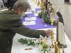 A visitor presses a personal item against a relic, thereby transforming it into a third-class relic suitable for personal prayer at home, during a sacred relics exhibit at Our Lady of Mount Carmel Oratory in Montclair on February 24, 2024. 