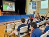 Dominic Auricchio’s family and classmates gather at Holy Trinity School in Westfield to watch his winning video and see Father Patrick Seo, director of the Archdiocese of Newark’s Office of Priestly Vocations, present him with his award.