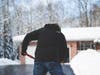 LS senior Nathan Gilbert shovels snow as part of his landscaping services.