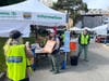 A watercolor painting of the Waltham Farmers Market is gifted to the retiring couple Leo Keightley and Martha Creedon by watercolor artist Maureen King. 