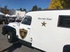 Old time sheriff’s paddy wagon at marketing display wooden benches inside. 