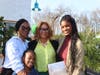 Golden Krust owner Lorna Brissett-Romans surrounded by daughters and granddaughter at the grand opening of her newest Golden Krust franchise in Plainfield.