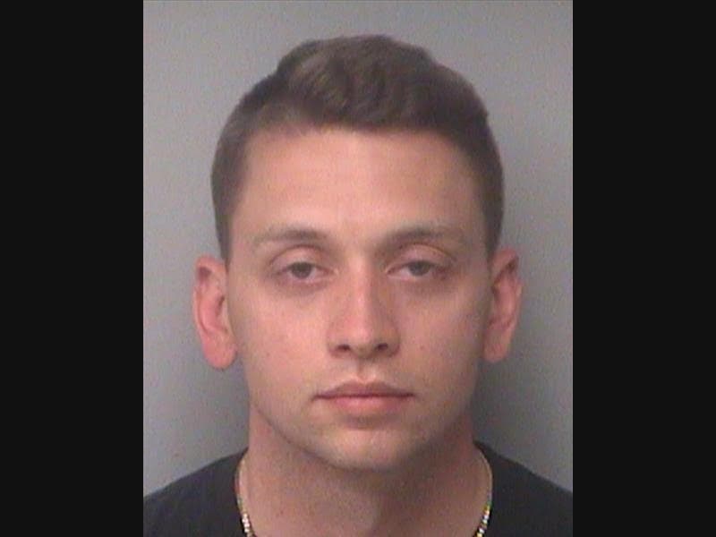 Jonathan Cain was fired from his job as a probationary officer for the St. Petersburg Police Department after he was arrested for attempting to use a woman's personal information to make purchases at Walmart.