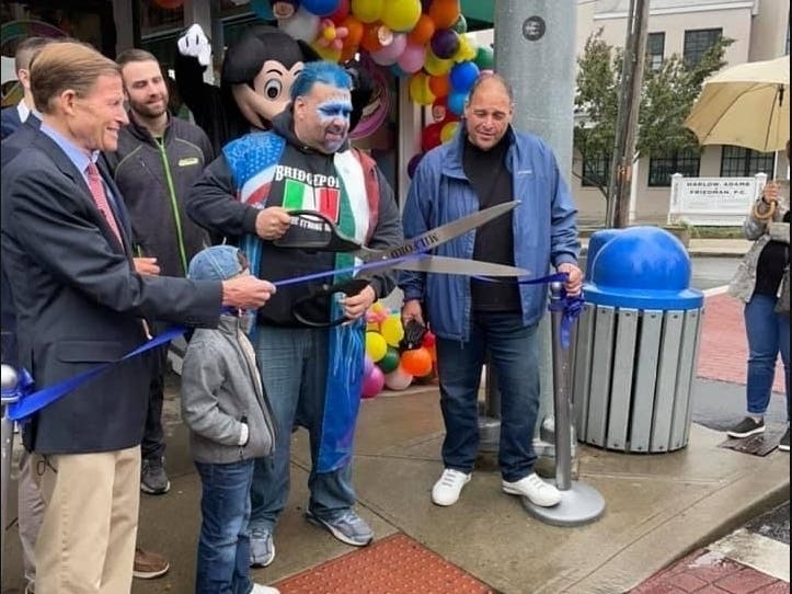 Jay Piccirillo, with scissors and dressed as his popular wrestling character The Iceman, at the Grand Opening of his new Milford shop Micalizzi's Italian Ice. The May 29 event welcomed Sen. Richard Blumenthal, left. 