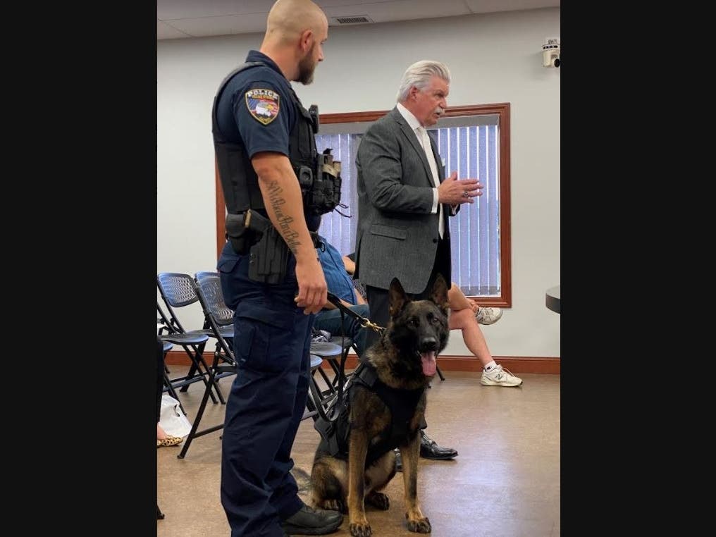 Monee Police officer Steve Crescenti (L), Cap, the department's new K-9, and Will County State’s Attorney James W. Glasgow. 