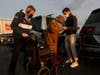 SANTA CLARA, CA - MARCH 03: Emil Hopner, 103, center, is helped into his wheelchair by his son Ben Hopner, right, and Glenn Bartkoviak of guest services, as he prepares to get his second COVID-19 vaccination at Levi’s Stadium on Wednesday, March 3, 2021. 