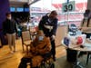 SANTA CLARA, CA - MARCH 03: Emil Hopner, 103, center, is helped by Glenn Bartkoviak of guest services as he prepares to get his second COVID-19 vaccination at Levi’s Stadium on Wednesday, March 3, 2021.