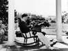 Oscar Hammerstein II at work on the porch of Highland Farm, seated in one of the iconic rocking chairs on display during the holiday season
