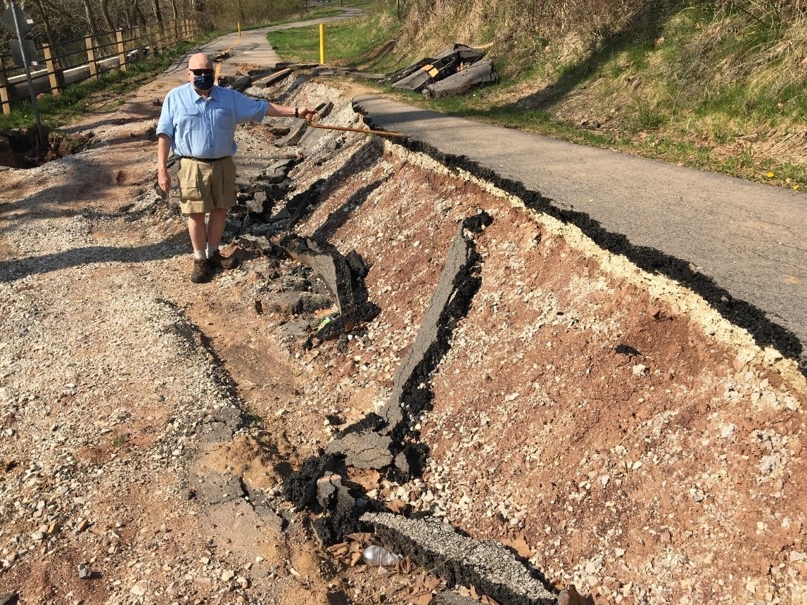 An image of Marietta City Councilman Mike Scales standing in the gaping void where a bike trail should be.
