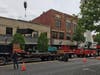 An image of a crane lifting material out of the building at 118 Putnam Street in downtown Marietta.