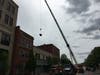 An image of a crane lifting material out of the building at 118 Putnam Street in downtown Marietta.