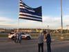 An image of the folks from American Flags and Poles getting the Blue Line flag ready