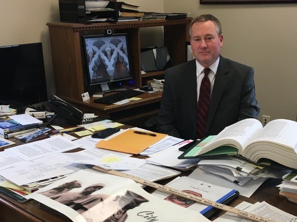 An image of Marietta Mayor Josh Schlicher at his desk in City Hall.