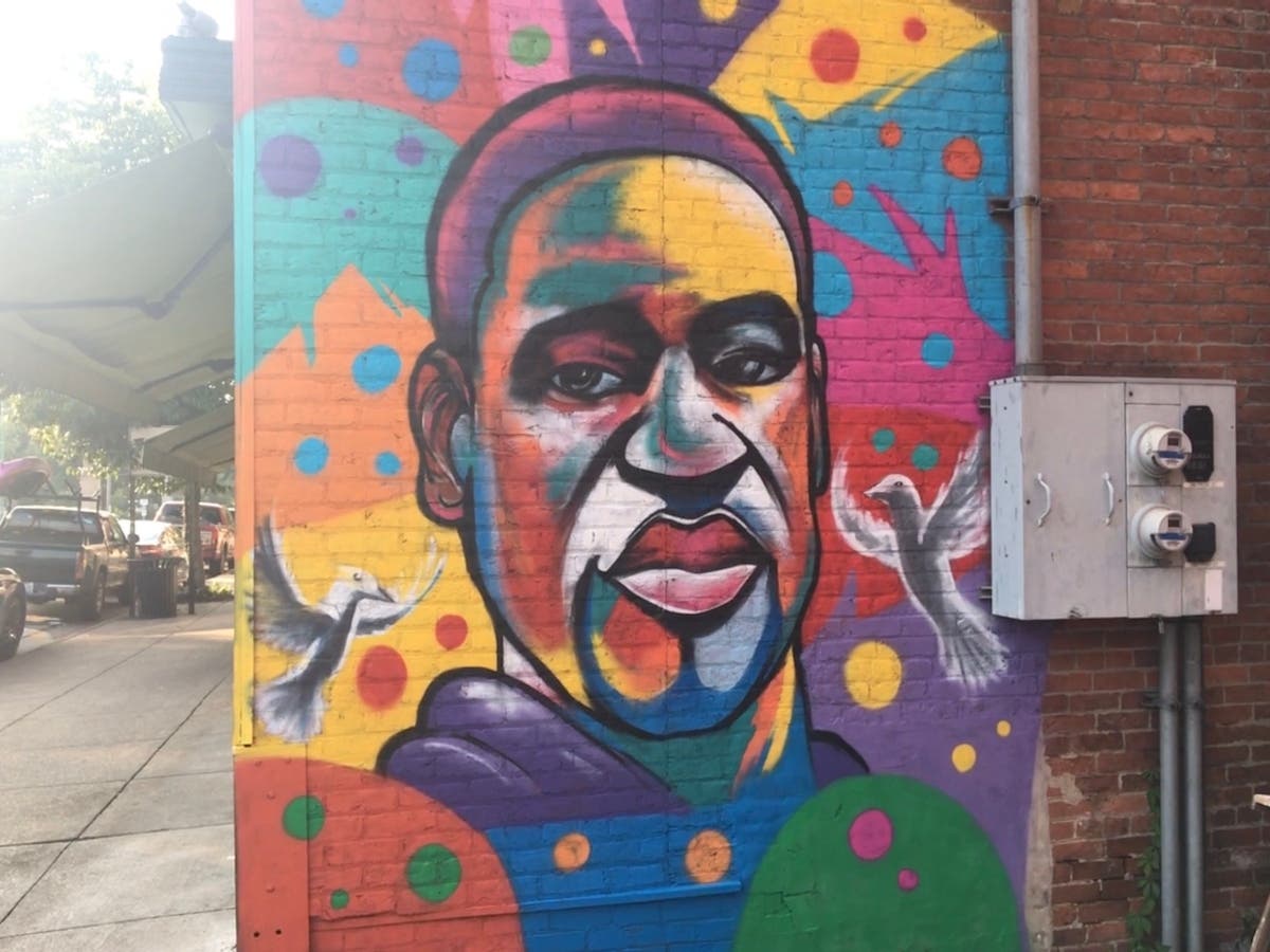 A George Floyd mural on the side of TLV Mediterranean Restaurant on Front Street.