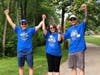 Janet Bauer (center), supported by brothers Jim Bychowski (left) and Jon Bychowski (right), walks in the 10th Annual Viking Challenge for MG on June 19 at Berens Park in Elmhurst. 