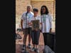 Conquer MG board members Bob Rosecrans (left) and Tammy Carter (right) present Elmhurst resident Executive Director Joan Wincentsen (center) with the “Above and Beyond Award’ for serving MG patients at the 10th Annual Viking Challenge for MG on June 19 at