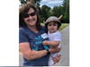 Marlene Rosecrans holds a young participant at the 10th Annual Viking Challenge for MG at Berens Park in Elmhurst on June 19.