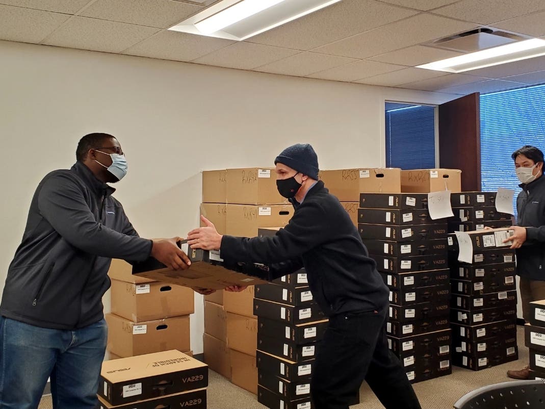Westchester Library System volunteers distribute computers for students in New Rochelle.