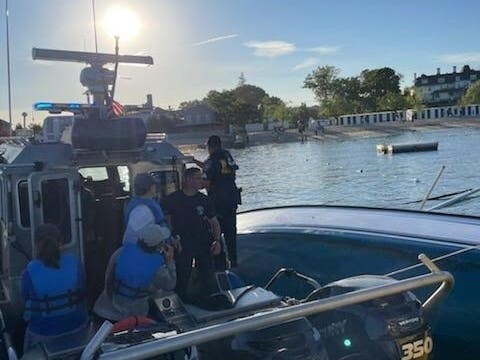 The rescued boaters are wearing the blue life vests.