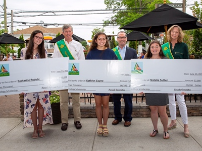 2021 Scholarship Winners Katharine Rudelic, Kathlyn Coyne and Natalie Sutter with Parade Grand Marshals Chris O’Callaghan, Joe Durney and Kate Bialo.