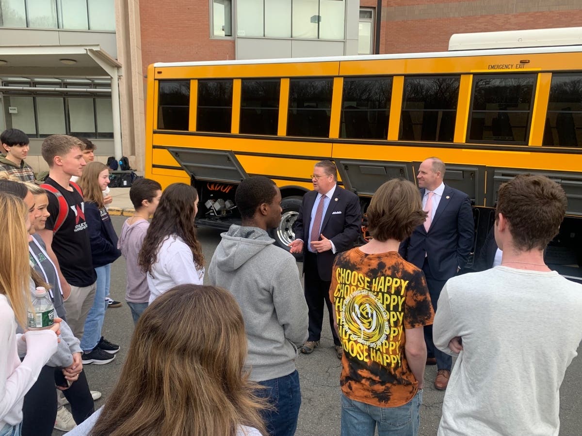 Sens. Harckham and Kennedy speak with Fox Lane High School students at the electric bus demonstration. 