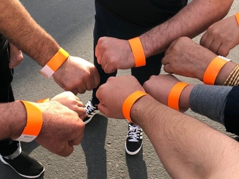 In October of 2021, relatives of the Ahmadi family living in a refugee center in the United Arab Emirates showed off orange wristbands signifying that they have been approved to come to the U.S.