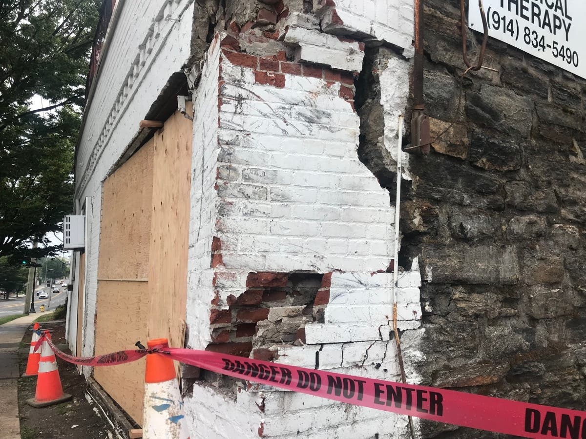 The vehicle left the road, struck a light pole and tree and then collided with the side of the building where the car came to rest on its driver’s side. 