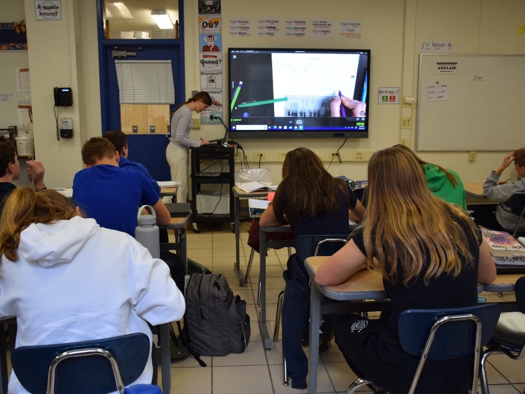 The secrets to time travel are on the screen at the front of the classroom. 