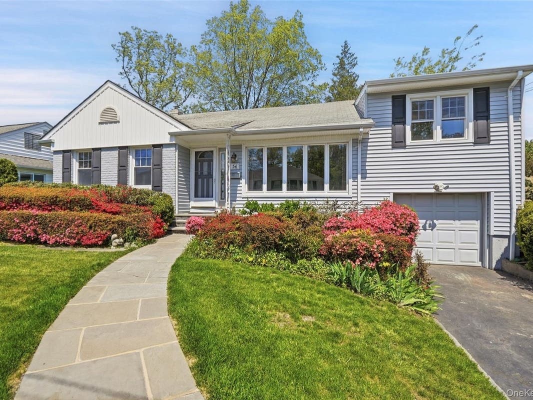 The listing, by Kori Sassower of Compass, says the four-bedroom, two-bathroom, 2,473-s.f. home "nestled on a serene cul-de-sac" in Scarsdale, "offers the perfect blend of space, comfort, and potential."