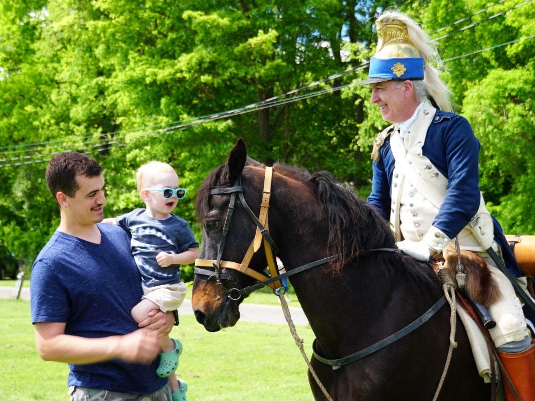 A historic reenactor greets guests at the Rochambeau Festival in Yorktown.
