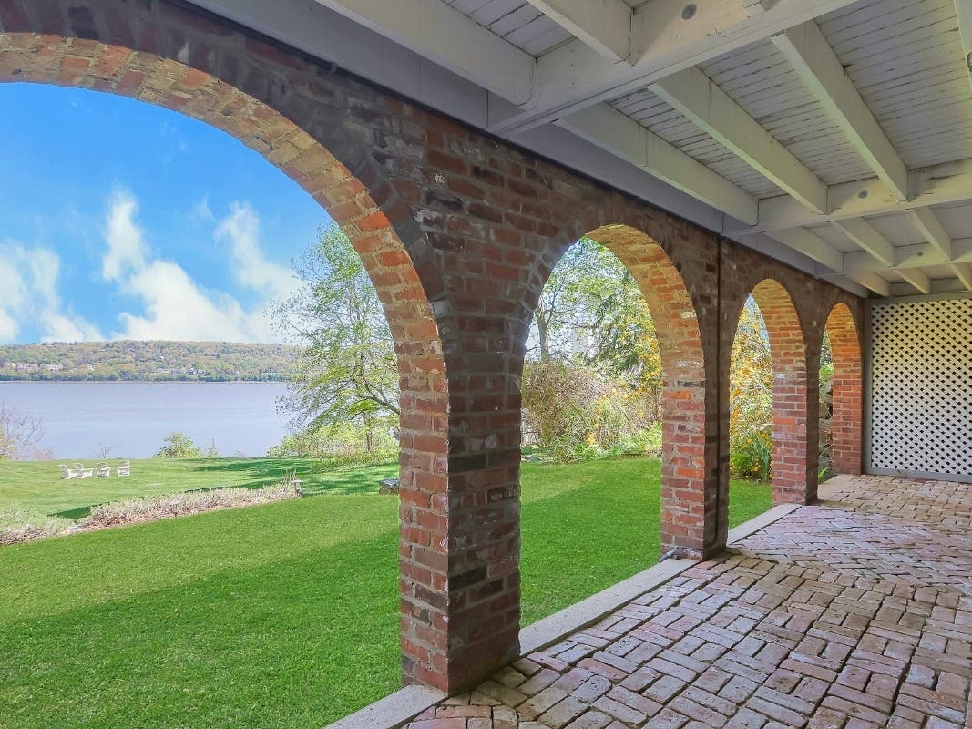The four-bedroom, four-bathroom, 4.700-s.f. home on Lawrence Lane is located on around 1.8 acres along 163 feet of private rocky and sandy shoreline with "sweeping" views of the Hudson River from almost every room.
