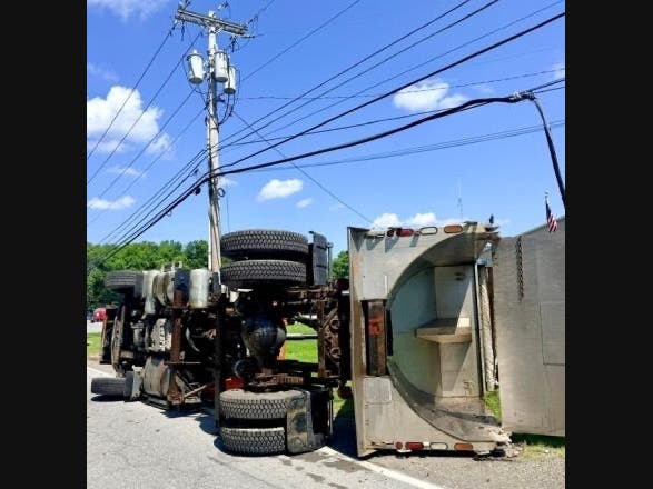 The cab guard caught overhead lines, lifting the truck’s front axle off the ground and causing the vehicle to roll onto its passenger side, police said.