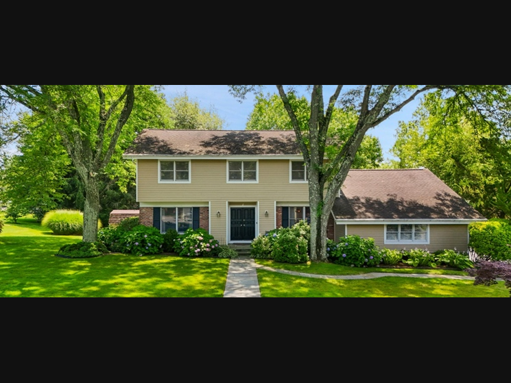 The home is described as a classic, well-maintained Colonial on a tree-lined street in the heart of Rye Brook. Set back from the road, the property includes a bluestone walkway and Hardie Plank siding, a big part of the home's curb appeal.