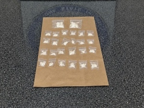 troopers found multiple plastic baggies containing approximately 21.5 grams of suspected cocaine in the car.