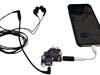 “Dumb” headphones can be plugged into a HeadFi device that connects to a cellphone, turning them into intelligent headphones. Engineers are working on a smaller version of the device.