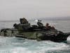 U.S. Marines with Co. A, 1st Battalion, 5th Marines, 1st Marine Division (1st MARDIV), and Co. B, 3d Assault Amphibian Battalion, 1st MARDIV, prepare to evacuate a P7/A1 assault amphibious vehicle (AAV) during a surf qualification.