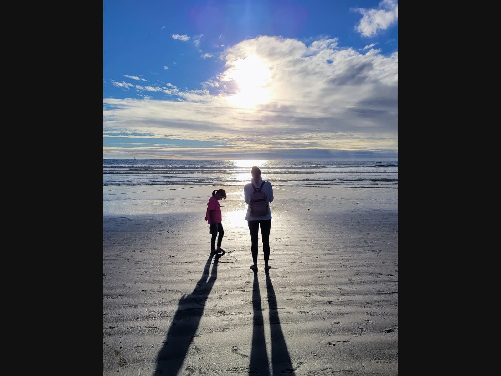 "I took this photo of my daughter and granddaughter adjacent to the harbor not long before sunset"