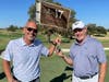 Pro golfer Hank Kuehne hands the keys to a new car to Michael Schodrof after he hit a hole-in-one. 