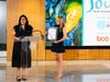 Councilmember Laura Cadena presents the Grant Halliburton Foundation with a special recognition for its 20th anniversary with Julia Beckel (holding it).